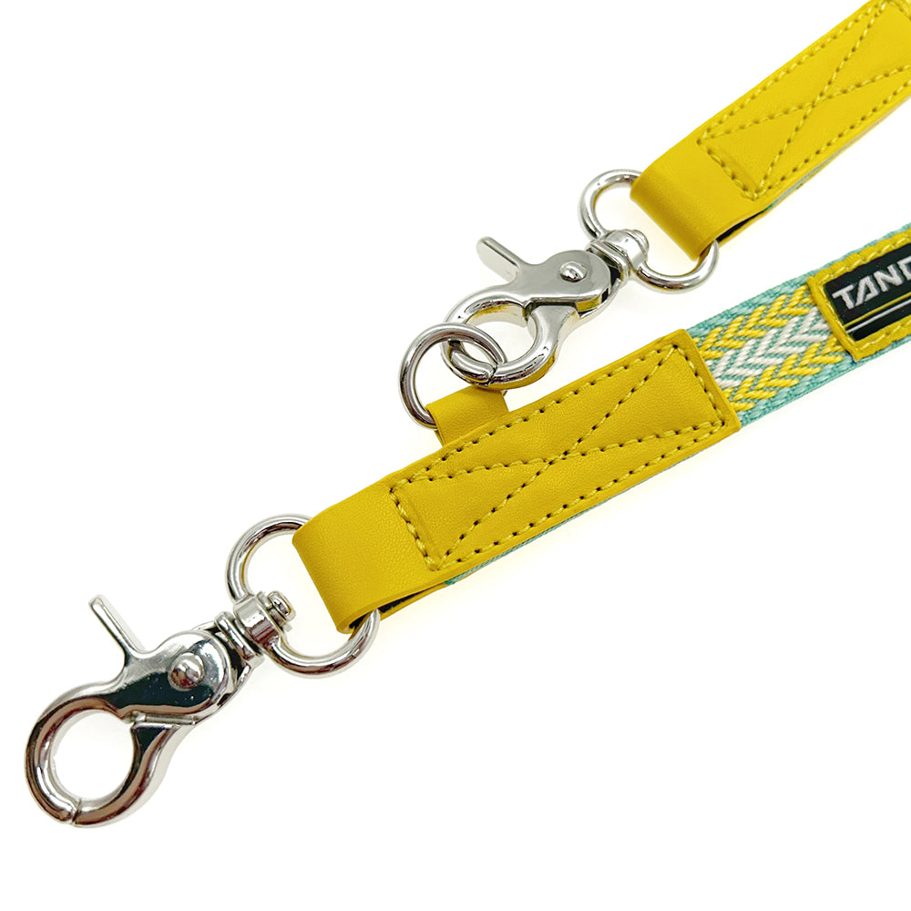Yellow leather strap with metal hooks.